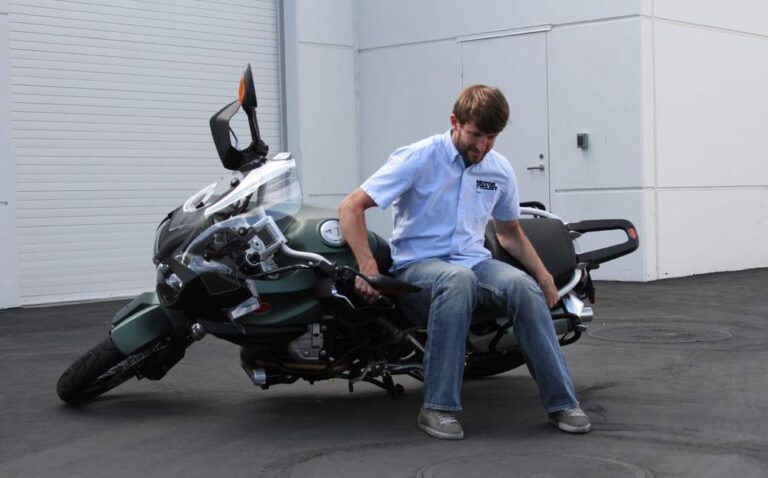 How do motorcycles stay upright when stopped?