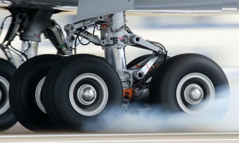 Why do plane wheels smoke?